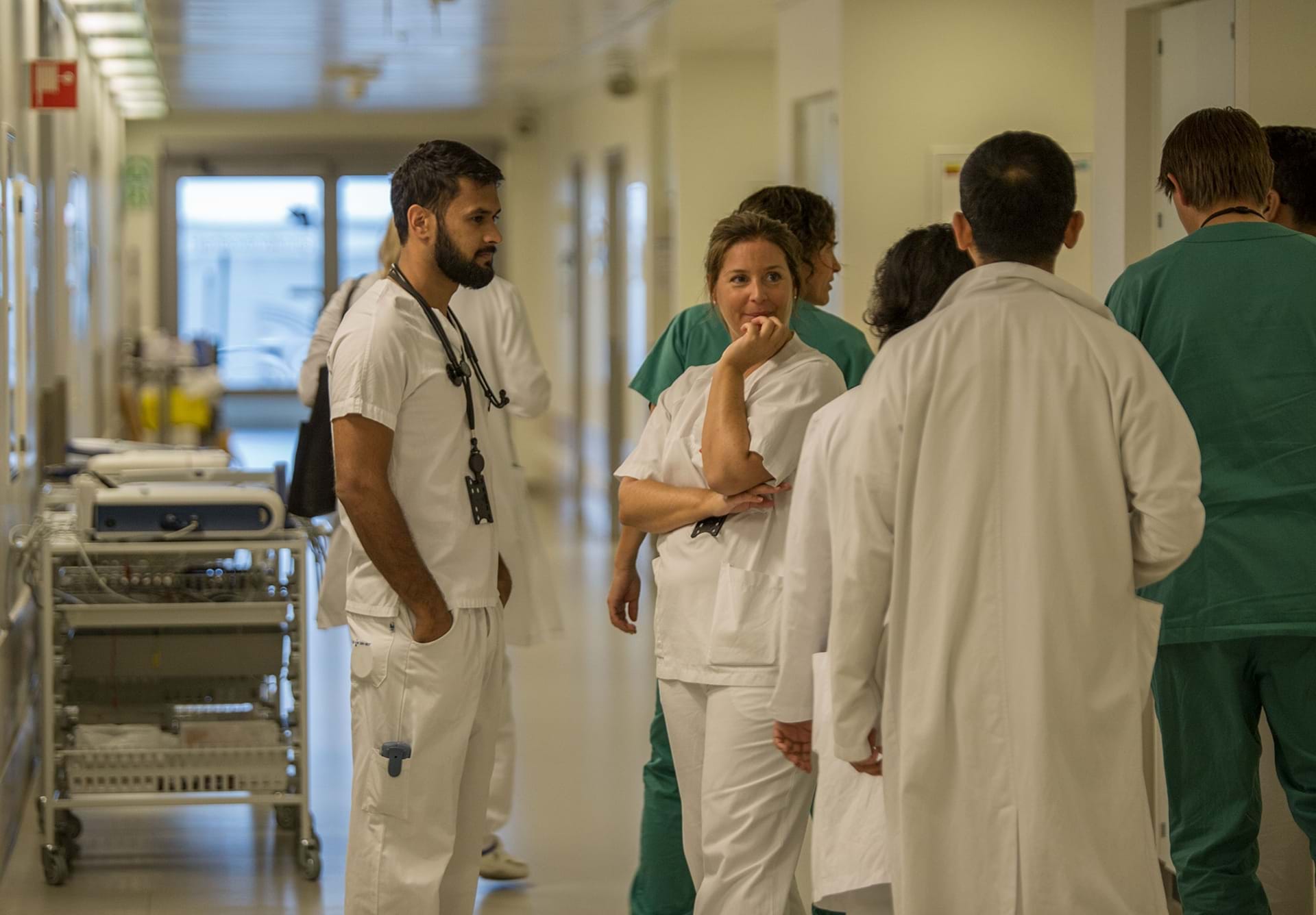 Leger og annet helsepersonell st&#229;ende i en sykehuskorridor. Foto: Legeforeningen/Thomas B. Eckhoff