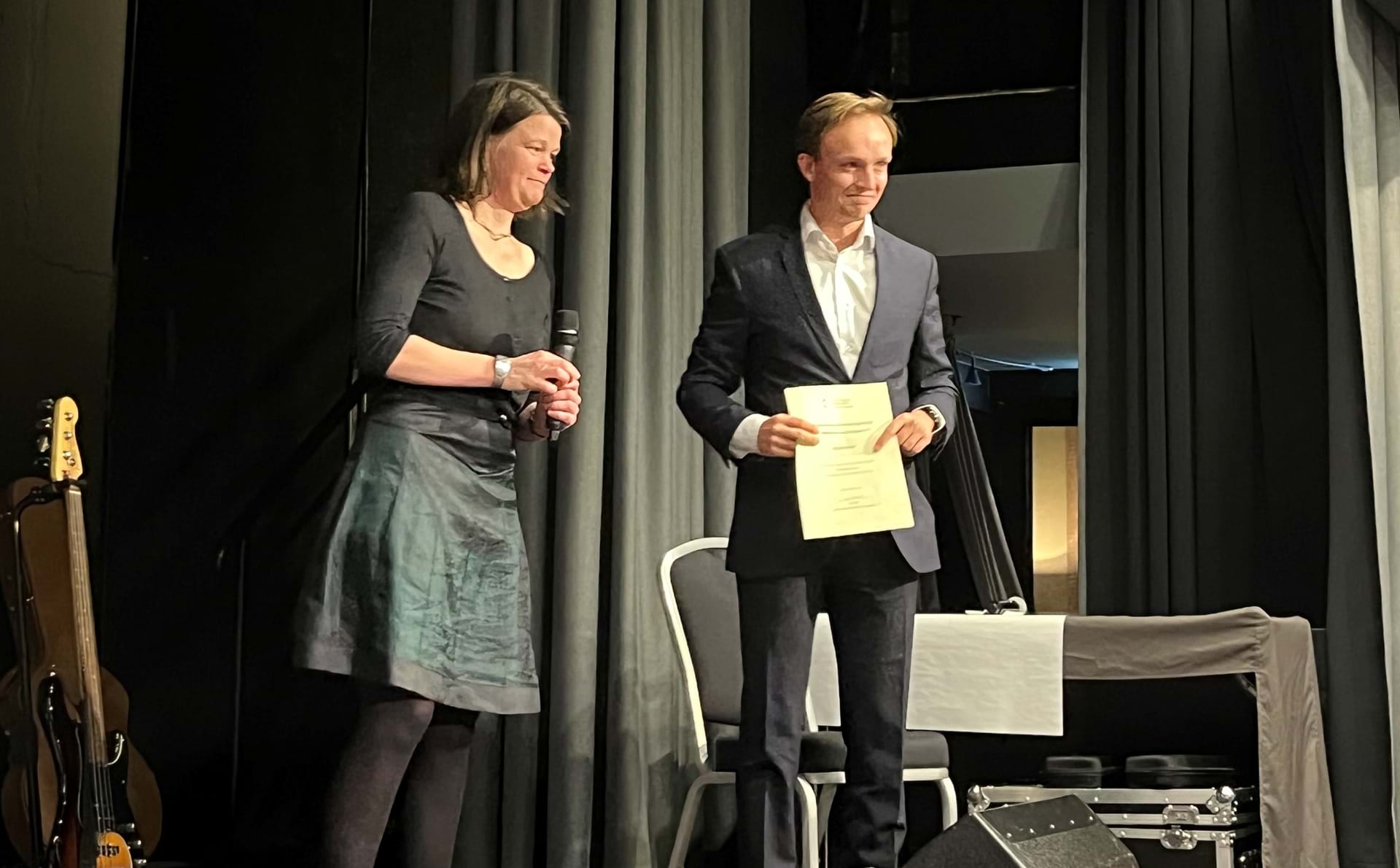 Man receiving award on stage, woman presenter next to him. Nicolai Klem and Anja Br&#230;nd