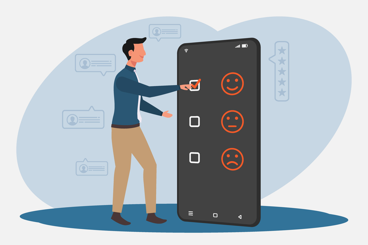 Man som står ved siden av en stor telefon og huker av på et smilefjes i en undersøkelse. Foto: Istockphoto.com/:fadfebrian