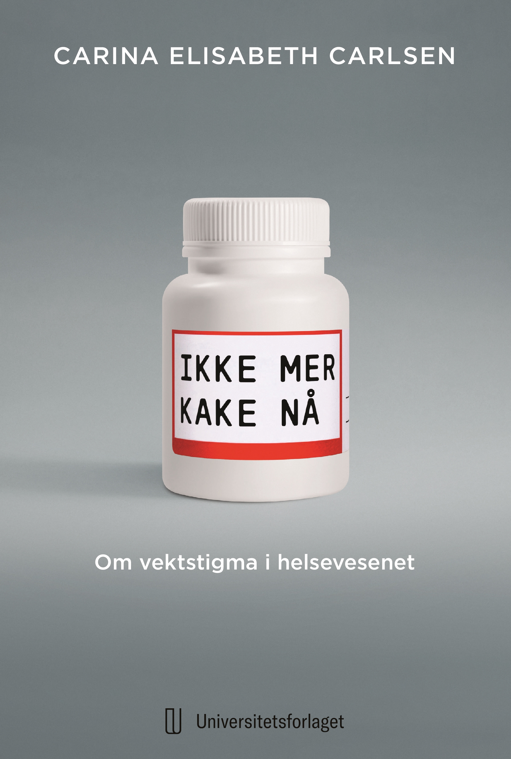 Grå bakgrunn. En hvit plastboks, medisinglass med påskriften "Ikke mer kake nå" i svart skrift.