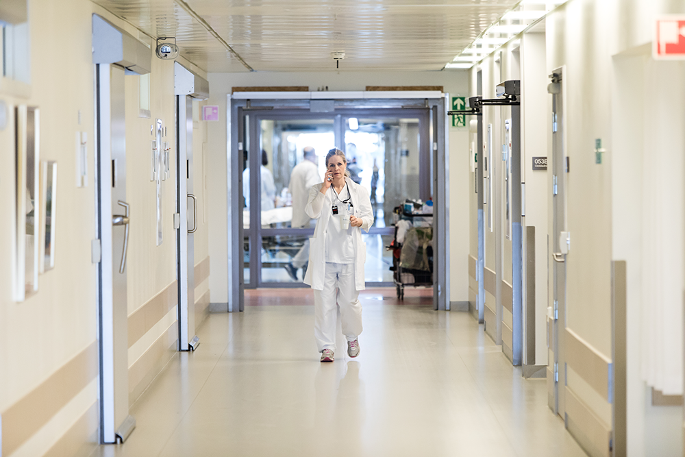 Lege g&#229;ende i en sykehuskorridor. Foto Thomas Barstad Eckhoff